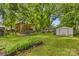 Lush backyard featuring a pergola, RV parking, and storage sheds at 119 Wiley Ave, Salisbury, NC 28144