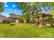 Backyard view featuring brick home with a pergola and greenhouse at 119 Wiley Ave, Salisbury, NC 28144