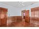 A bedroom with wood floors, baseboards, and trim, plus three doors at 119 Wiley Ave, Salisbury, NC 28144