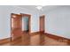 A bedroom with wood floors, baseboards, and trim, plus two doors at 119 Wiley Ave, Salisbury, NC 28144