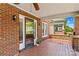 Cozy covered porch featuring brick columns, tiled flooring, and a view of the surrounding neighborhood at 119 Wiley Ave, Salisbury, NC 28144