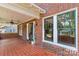 Inviting covered porch with brick details, ceiling fan, and large windows offering natural light and curb appeal at 119 Wiley Ave, Salisbury, NC 28144