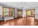 Open living room featuring hardwood floors, a decorative fireplace, and elegant wood trim for a classic appeal at 119 Wiley Ave, Salisbury, NC 28144