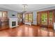 Spacious living room with hardwood floors, fireplace, built-in cabinets, and natural light creates a cozy and inviting space at 119 Wiley Ave, Salisbury, NC 28144