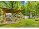 Backyard pergola with blue patio seating and a view of the lush greenery at 119 Wiley Ave, Salisbury, NC 28144