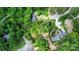 An aerial view of several large homes next to a lake are connected by winding roads lined with lush greenery at 136 Dogwood Ln, Shelby, NC 28150