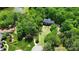An aerial view shows a beautiful brick home with a large, well-maintained lawn surrounded by mature trees at 136 Dogwood Ln, Shelby, NC 28150