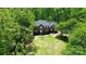 A beautiful brick home featuring classic architecture with a well-manicured lawn and mature trees at 136 Dogwood Ln, Shelby, NC 28150