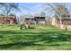 Expansive backyard with lush green lawn and a wooden playset, perfect for outdoor fun at 1628 Starbrook Dr, Charlotte, NC 28210