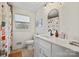 Bathroom with a white vanity, modern fixtures, and a shower-tub combination with a playful shower curtain at 1628 Starbrook Dr, Charlotte, NC 28210