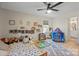Bright, carpeted bedroom with a ceiling fan, natural light, and ample space for playing at 1628 Starbrook Dr, Charlotte, NC 28210