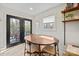 Bright dining area with wooden table, modern chairs, and access to an outdoor deck through glass doors at 1628 Starbrook Dr, Charlotte, NC 28210