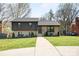 Beautifully updated home with a brick and dark gray exterior and a well-kept front yard at 1628 Starbrook Dr, Charlotte, NC 28210