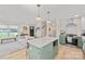 Stylish kitchen island with pendant lighting, modern appliances and open view to the living room at 1628 Starbrook Dr, Charlotte, NC 28210