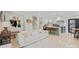 Cozy living room with a soft sofa opening to a modern kitchen and staircase at 1628 Starbrook Dr, Charlotte, NC 28210