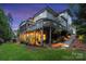 Exterior view showcasing a large deck and a landscaped backyard at 18730 Floyd Ct, Davidson, NC 28036