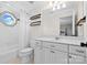 Bathroom with a window, a vanity, a toilet, and a shower with a curtain at 18730 Floyd Ct, Davidson, NC 28036