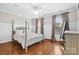 Bedroom featuring hardwood floors, a ceiling fan, a window, and a dresser at 18730 Floyd Ct, Davidson, NC 28036