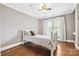 Bedroom with a window, crown molding, hardwood floors, and a ceiling fan at 18730 Floyd Ct, Davidson, NC 28036