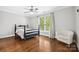 Bedroom featuring hardwood floors, a ceiling fan and a chair near the window at 18730 Floyd Ct, Davidson, NC 28036