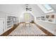 Large bonus room with hardwood floors, skylights, built-in shelves, and a table at 18730 Floyd Ct, Davidson, NC 28036