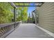 Spacious back deck features a closed grill and wooded scenery beyond the railing at 18730 Floyd Ct, Davidson, NC 28036