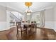 Elegant dining room featuring hardwood floors, a chandelier, and large windows at 18730 Floyd Ct, Davidson, NC 28036