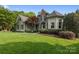 Charming two-story home with manicured lawn and stone accents, surrounded by mature landscaping at 18730 Floyd Ct, Davidson, NC 28036