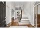 Grand foyer with hardwood floors, curved staircase, and open view to the upper level at 18730 Floyd Ct, Davidson, NC 28036