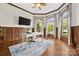 Bright home office featuring wood paneling, hardwood floors, and plenty of natural light at 18730 Floyd Ct, Davidson, NC 28036