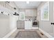 Well-lit laundry room with modern washer and dryer, ample storage, and neutral tones for a clean and efficient space at 18730 Floyd Ct, Davidson, NC 28036