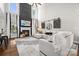 Bright living room with fireplace, soaring ceilings, and stylish decor and large windows at 18730 Floyd Ct, Davidson, NC 28036