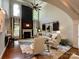 Bright living room with fireplace, soaring windows, and elegant seating arrangement under a high ceiling at 18730 Floyd Ct, Davidson, NC 28036