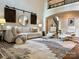 Elegant living room with a cozy sectional sofa, stylish chairs, and decor under a high ceiling at 18730 Floyd Ct, Davidson, NC 28036