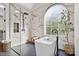 Luxurious main bathroom with a freestanding tub, glass shower, and marble accents, offering a spa-like experience at 18730 Floyd Ct, Davidson, NC 28036