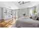 Inviting main bedroom with hardwood floors, custom built-ins, and soft lighting, creating a cozy and stylish retreat at 18730 Floyd Ct, Davidson, NC 28036