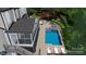 Inviting backyard oasis featuring a stunning pool, spa, and manicured landscaping, perfect for outdoor relaxation at 18730 Floyd Ct, Davidson, NC 28036