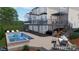 Backyard with a luxurious pool and spa combination, complemented by a spacious deck and lush greenery at 18730 Floyd Ct, Davidson, NC 28036