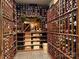 Spacious wine cellar with wooden racks storing numerous bottles of wine on tile floor at 18730 Floyd Ct, Davidson, NC 28036