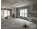 Open-concept living room featuring a fireplace, and a large window allowing ample light at 19028 Newburg Hill Rd, Davidson, NC 28036