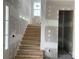 View of the unfinished staircase leading to the upper level, with natural light from the window at 19028 Newburg Hill Rd, Davidson, NC 28036