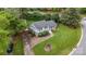 Aerial view of a charming home with a lush green lawn, mature trees, and a paved driveway at 2100 Shadyview Dr, Charlotte, NC 28210