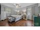 Inviting bedroom with hardwood floors, soft lighting, and a peaceful atmosphere with ample natural light at 2100 Shadyview Dr, Charlotte, NC 28210
