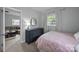 Bedroom with a blue dresser and patterned bedspread; view into a living room beyond at 2100 Shadyview Dr, Charlotte, NC 28210