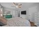 Calm bedroom featuring a ceiling fan, hardwood floors, and ample natural light with a view of the outside at 2100 Shadyview Dr, Charlotte, NC 28210