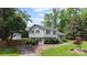 Charming home with a well-kept lawn, mature trees, and a fenced yard, creating a serene setting at 2100 Shadyview Dr, Charlotte, NC 28210