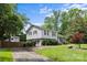 Charming two-story home with a beautifully landscaped front yard, fenced area, and well-maintained lawn at 2100 Shadyview Dr, Charlotte, NC 28210