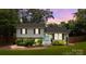 Charming split-level home with a light blue front door, beautiful landscaping, and a cozy feel at 2100 Shadyview Dr, Charlotte, NC 28210