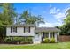 Inviting two-story home featuring a well-maintained lawn, mature trees, and classic architectural details at 2100 Shadyview Dr, Charlotte, NC 28210