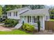 Exterior view of home featuring brick accents, well-kept landscaping, and a inviting light blue door at 2100 Shadyview Dr, Charlotte, NC 28210